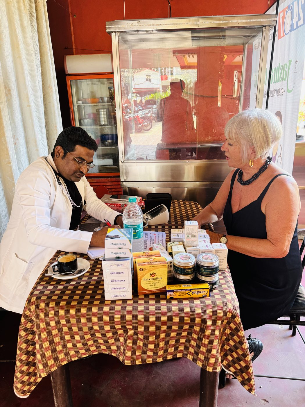 Dr. Raju checking a patient's blood pressure at the clinic